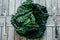 Fresh Green Kale most useful vegetables on wooden background wit