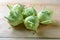Fresh green kohlrabi or german turnip or turnip cabbage on wood background.