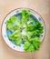 Fresh green lettuce leaves on hand painted terracotta dish