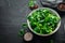 Fresh green lettuce salad in a plate on a wooden background Top view. Free space for your text.