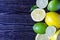 Fresh green limes, yellow lemons on a wooden background lime and lemon in the section of