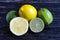 fresh green limes, yellow lemons on a wooden background lime and lemon in a section