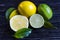 Fresh green limes, yellow lemons on a wooden background lime and lemon in a  section