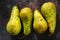 Fresh green long pears on rustic metal sheet