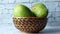 Fresh green mango in a bowl on table