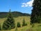 Fresh green meadows, blooming flowers, typical farmhouses and snowcapped mountain tops in the background