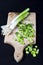 Fresh green organic chopped onions on a cutting board