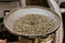 Fresh Green Organic Natural Coffee Beans being Poured into Industrial Coffee Roasting Machine in a Coffee Shop