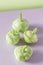 Fresh green patissons on a purple background. Conceptual minimalism