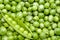 Fresh green pea pod on peas background