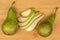 Fresh green pear on light wood