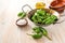 Fresh green pimientos or padron peppers, sea salt, olive oil and empty Spanish tapa bowls on a light wooden table, copy space,