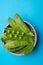 Fresh green ripe green peas in bowl copy space close up isolated