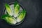 Fresh Green Romaine Lettuce for Caesar Salad on dark stone background