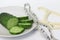 Fresh green sliced cucumber with a measuring tape and a caliper on white background as a concept of slimming diet and lose weight
