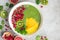 fresh green smoothie bowl with spinach, mango, kiwi and raspberry. Healthy vegan raw food