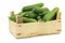 Fresh green snack cucumbers in a wooden box