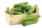 Fresh green snack cucumbers in a wooden box