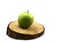 Fresh green spotted apple and wooden circle