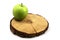 Fresh green spotted apple and wooden circle