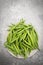 Fresh green string beans on a plate isolated on a grey structured background