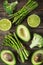 Fresh green vegetables asparagus, avocado, lime, broccoli and g