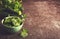 Fresh green vegetables in a bowl and on the table