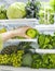 Fresh green vegetables and fruits in fridge. Woman takes the green apple from the open refrigerator.