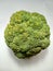 a fresh, green and very large broccoli seen from above on a white background