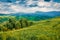 Fresh green view of Carpathians with Hoverla and Petros peaks on background