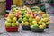 Fresh green and yellow lemons placed on baskets on the floor at the street market of Toliara, Madagascar