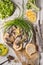 Fresh greens, sardines, bread on a wooden table