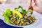 fresh grilled mussels with herbs and lemon on white plate, selective focus