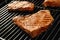 Fresh grilled tasty meat steaks on barbecue grate