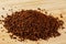 Fresh ground Roasted Coffee Grounds wooden background