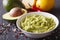 Fresh guacamole sauce with ingredients close-up. horizontal