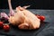 Fresh halal chicken carcass on a gray background, fresh meat, copy space, photo for grocery stores. dark background