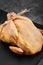 Fresh halal chicken carcass on a gray background, fresh meat, copy space, photo for grocery stores. dark background