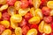 Fresh halves of Brazilian cherry tomatoes. Background of many colorful cherry tomatoes. Sliced yellow and red cherry tomatoes.