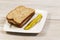 Fresh Ham Sandwich with Sliced Pickle on White Plate