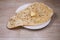 Fresh and hanging bread on gray cement background with copy space. Top view of several perfect flower loaves