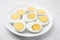 Fresh hard boiled eggs on white tiled table