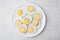 Fresh hard boiled eggs on white tiled table, top view