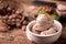 Fresh hazelnut ice cream on wooden table.