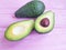 Fresh health avocado on a pink wooden