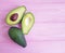 Fresh health avocado on a pink wooden minimalism