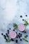 Fresh healthy blueberries smoothie berries and mint in glass on light white concrete background.