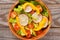 Fresh healthy close up salad with cos lettuce, cherry tomatoes,pepper,radish on wooden background