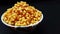 fresh and healthy deep fried gram flour balls in bowl isolated on black background