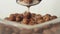 Fresh healthy food. Spoon grabs chocolate cereal balls with milk from transparent bowl on a white background. The concept